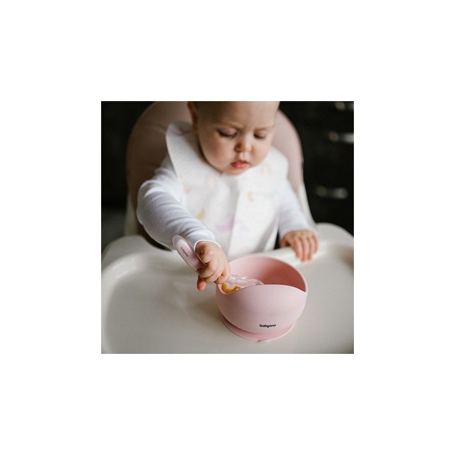 Une bouteille en silicone avec une sucette rose